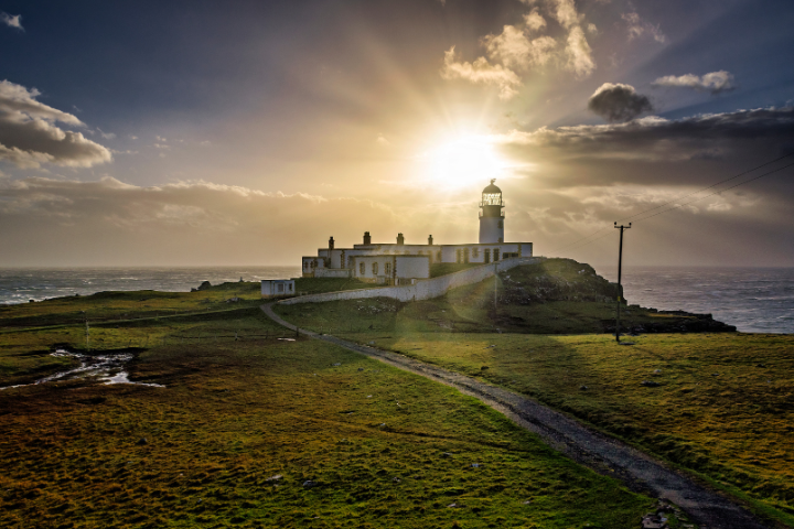 Winding coastal road on the Isle of Skye with dramatic landscape backdrop